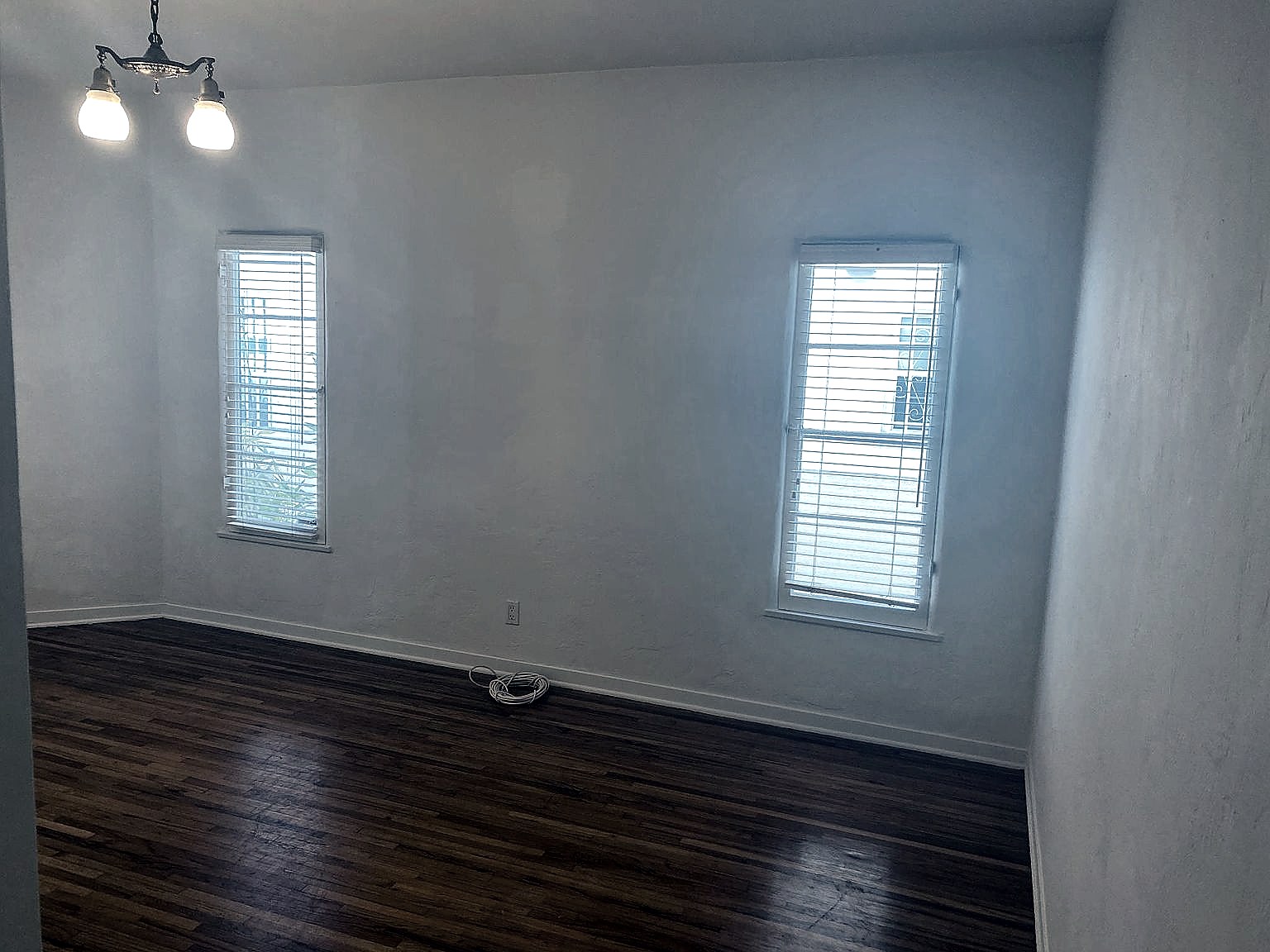 Bedroom with hardwood floors and tall windows